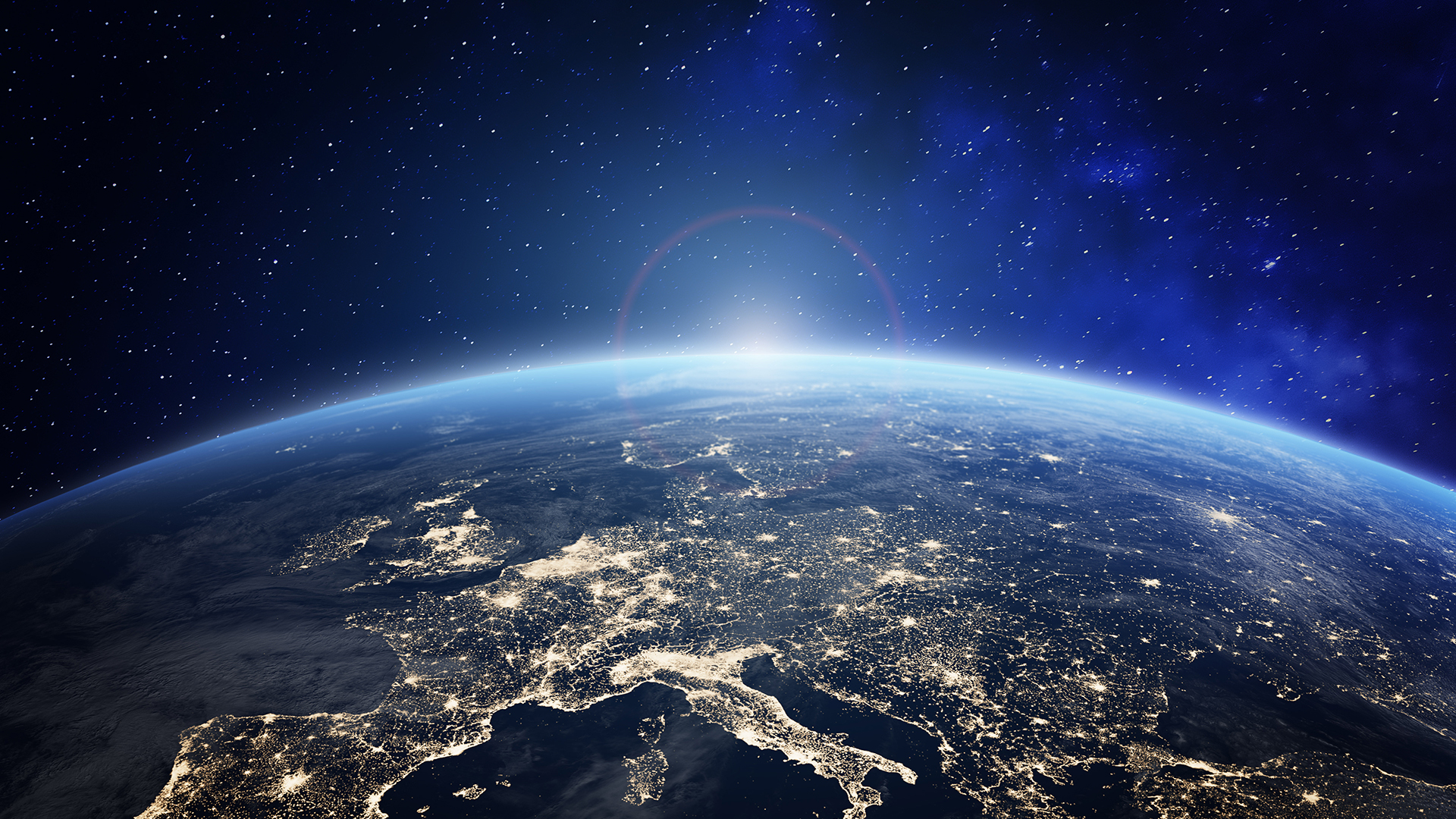 Planet Earth viewed from space with city lights in Europe. World with sunrise. Conceptual image for global business or European communication technology, elements from NASA
